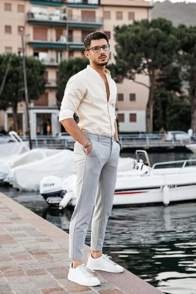 Homem usando camisa social, calça chino e tênis minimalista.